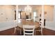 Elegant dining room features a chandelier, wood floors, and a round table for four at 351 Washington Ne Ave # 208, Marietta, GA 30060