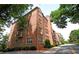 Charming brick condo building with clock tower, balconies, and easy access to a peaceful road at 351 Washington Ne Ave # 208, Marietta, GA 30060