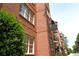 Close-up of a classic brick building with ample windows and a street sign showcasing a desirable address at 351 Washington Ne Ave # 208, Marietta, GA 30060