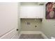 Laundry room with white cabinets and tile floors at 351 Washington Ne Ave # 208, Marietta, GA 30060