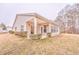 Rear view of house, showcasing patio and landscaping at 700 Brambling Way, Stockbridge, GA 30281