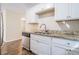 Kitchen boasts granite countertops and white cabinets at 3212 Ward Sw Dr, Atlanta, GA 30354