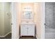 Updated bathroom with white vanity and marble tile at 5063 S Woodbridge Trl, Stone Mountain, GA 30088