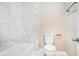 Clean bathroom with a shower/tub and updated toilet at 5063 S Woodbridge Trl, Stone Mountain, GA 30088