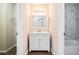 Bathroom with white vanity, marble tile, and a bathtub at 5063 S Woodbridge Trl, Stone Mountain, GA 30088