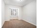 Bright bedroom featuring a large window and neutral wall tones at 5063 S Woodbridge Trl, Stone Mountain, GA 30088