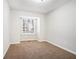 Charming bedroom with neutral carpet and large window at 5063 S Woodbridge Trl, Stone Mountain, GA 30088