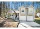 Gray two-story house with a two-car garage and a well-manicured lawn at 5063 S Woodbridge Trl, Stone Mountain, GA 30088