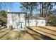 Rear view of house showcasing a large backyard and patio at 5063 S Woodbridge Trl, Stone Mountain, GA 30088