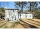 Back exterior view shows a gray house and backyard at 5063 S Woodbridge Trl, Stone Mountain, GA 30088