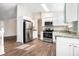 Modern kitchen with granite countertops and stainless steel appliances at 5063 S Woodbridge Trl, Stone Mountain, GA 30088