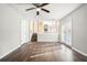 Living room with hardwood floors, a ceiling fan and access to a deck at 5063 S Woodbridge Trl, Stone Mountain, GA 30088