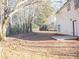 Side yard with a view of the house and wooded area at 2655 Brandenberry Dr, Decatur, GA 30034