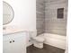 Updated bathroom with gray tile, white vanity, and modern bathtub at 2655 Brandenberry Dr, Decatur, GA 30034