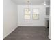 Spacious dining area with gray vinyl plank flooring and modern light fixture at 2655 Brandenberry Dr, Decatur, GA 30034