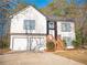 Two-story house with white siding, brown accents, and a two-car garage at 2655 Brandenberry Dr, Decatur, GA 30034