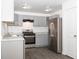 Bright kitchen, gray cabinets, stainless steel appliances, and vinyl flooring at 2655 Brandenberry Dr, Decatur, GA 30034