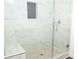 Modern shower with glass enclosure, marble tile, and built-in seat at 2655 Brandenberry Dr, Decatur, GA 30034