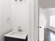 Cozy powder room featuring a modern vanity with stone countertop and stylish fixtures at 147 Bowen Sw Cir, Atlanta, GA 30315