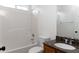 Clean bathroom with a tub and shower combination, a decorative vanity with an accent mirror and modern fixtures at 147 Bowen Sw Cir, Atlanta, GA 30315