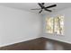 Cozy bedroom with natural light from large windows, accentuating hardwood floors and a modern ceiling fan at 147 Bowen Sw Cir, Atlanta, GA 30315