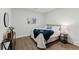 Comfortable bedroom with neutral walls, wood floor, accent decor, and a cozy bed with a blue blanket at 147 Bowen Sw Cir, Atlanta, GA 30315
