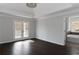 Bright bedroom with hardwood floors, balcony access, and a glimpse of the ensuite at 147 Bowen Sw Cir, Atlanta, GA 30315