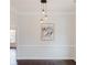 Elegant dining room featuring dark wood floors, modern lighting, and decorative wall art at 147 Bowen Sw Cir, Atlanta, GA 30315