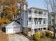 Two-story home featuring a double front porch, complemented by brick accents and a two car garage at 147 Bowen Sw Cir, Atlanta, GA 30315