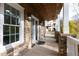 Inviting front porch with brick columns, exterior lighting and a wood ceiling at 147 Bowen Sw Cir, Atlanta, GA 30315