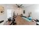Spacious home gym with exercise equipment, wood flooring, large fan, and natural light at 147 Bowen Sw Cir, Atlanta, GA 30315