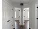 Bright hallway with white doors leading to bedrooms, showcasing the layout and flow of the home at 147 Bowen Sw Cir, Atlanta, GA 30315