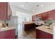 Well-equipped kitchen with granite countertops, stainless steel appliances, and cherry wood cabinets at 147 Bowen Sw Cir, Atlanta, GA 30315