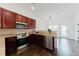 Well-equipped kitchen with granite countertops, stainless steel appliances, and cherry wood cabinets at 147 Bowen Sw Cir, Atlanta, GA 30315