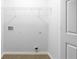 A bright laundry room with overhead shelving and clean, functional space for laundry appliances and storage at 147 Bowen Sw Cir, Atlanta, GA 30315