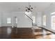 Open-concept living space boasts hardwood flooring and modern lighting at 147 Bowen Sw Cir, Atlanta, GA 30315