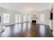 Spacious living room with abundant natural light, a cozy fireplace, and elegant hardwood floors at 147 Bowen Sw Cir, Atlanta, GA 30315