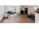 Open-concept living room with gray seating, wood flooring, and natural light at 147 Bowen Sw Cir, Atlanta, GA 30315