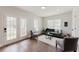 Cozy living room featuring wood floors, neutral decor, and abundant natural light at 147 Bowen Sw Cir, Atlanta, GA 30315