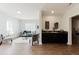 Bright open-concept living room with a modern bar area and hardwood floors at 147 Bowen Sw Cir, Atlanta, GA 30315