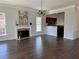 Bright living room featuring hardwood floors, a fireplace, and an open layout connected to the kitchen at 147 Bowen Sw Cir, Atlanta, GA 30315