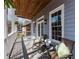 Inviting porch area with seating and a decorative wood ceiling at 147 Bowen Sw Cir, Atlanta, GA 30315