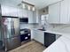 Modern kitchen with stainless steel appliances and white cabinets at 6076 Belle Meade Dr, Villa Rica, GA 30180