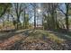 Wooded backyard with a partially visible house in the background at 2592 Baker Nw Rd, Atlanta, GA 30318