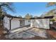 White brick ranch house with a sliding glass door and detached structure in the back at 2592 Baker Nw Rd, Atlanta, GA 30318