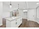 Eat-in kitchen with white cabinets, island, and hardwood floors at 2592 Baker Nw Rd, Atlanta, GA 30318