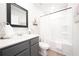 Well-lit bathroom with a vanity, mirror, shower, and decorative accents at 257 Whitetail Cir, Canton, GA 30115