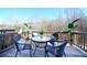 Outdoor deck featuring a table, chairs, potted plants, and a scenic view of the surrounding woods at 257 Whitetail Cir, Canton, GA 30115