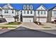 New construction townhouse with symmetrical design and attached garages in a modern community at 257 Whitetail Cir, Canton, GA 30115