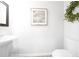 Elegant powder room featuring a pedestal sink, modern art, and a decorative wreath at 257 Whitetail Cir, Canton, GA 30115